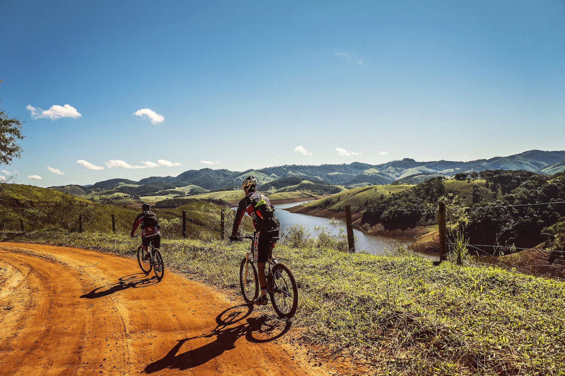 bicyclist passing the road near the river