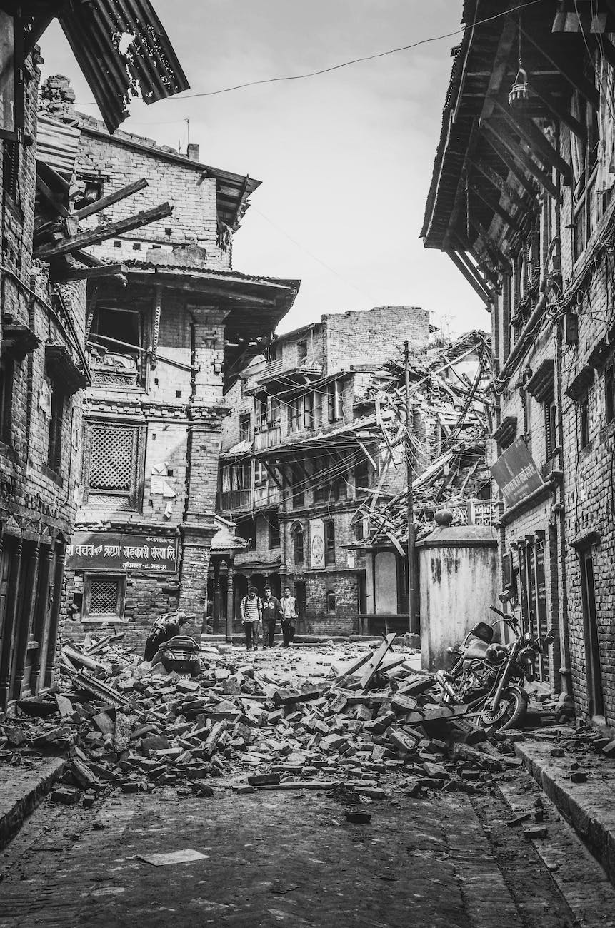 people walking near wrecked buildings